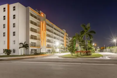 an empty street in front of a building at night at Landing Incredible 3BD Pool Gym in Naranja