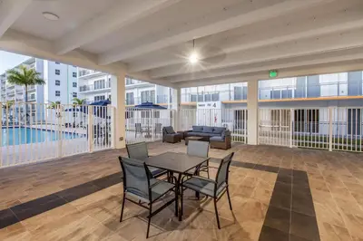 a living room with a table and chairs and a couch at Landing Incredible 3BD Pool Gym in Naranja