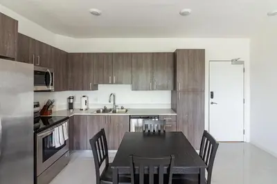 a kitchen with a black table and chairs in it at Landing Incredible 3BD Pool Gym in Naranja