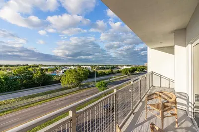 a balcony with a view of a road at Landing Incredible 3BD Pool Gym in Naranja