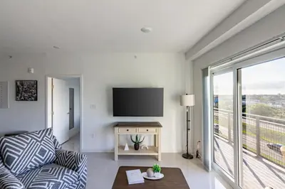 a living room with a couch and a flat screen tv at Landing Incredible 3BD Pool Gym in Naranja