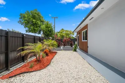 a home with a fence and a yard at Villa Gabriel Modern, Family Home Just 15 minutes downtown Miami in Miami