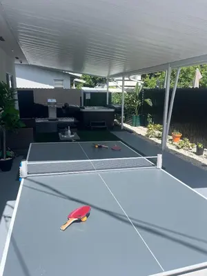 a ping pong table in the middle of a patio at Villa Gabriel Modern, Family Home Just 15 minutes downtown Miami in Miami