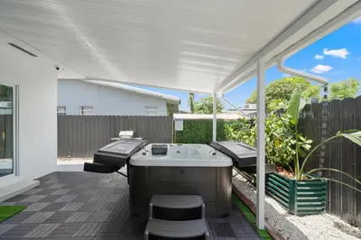 a hot tub on the patio of a house at Villa Gabriel Modern, Family Home Just 15 minutes downtown Miami in Miami
