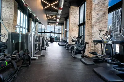 a gym with a row of treadms and machines at Downtown Skyline Heights with Stunning Ocean View in Miami