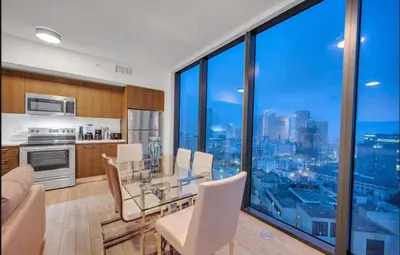 a kitchen and dining room with a view of the city at Downtown Miami Excape in Miami