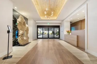 an office hallway with a large lobby with a ceiling at Amazing Ocean and 1 Hotel pool Views 2BR 3BA w Balcony in Miami Beach