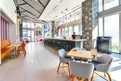 a restaurant with tables and chairs and a bar at Stylish Studio in Brickell Core in Miami