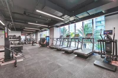 a gym with treadmills and machines in a room at Stylish Studio in Brickell Core in Miami