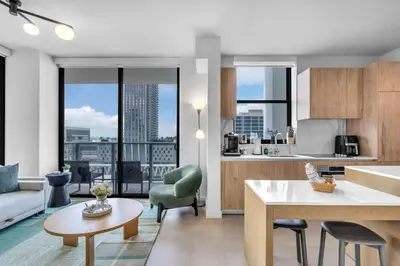 a kitchen and living room with a view of a city at Luxury 2 Bedroom Corner Unit Crosby Rooftop Pool in Miami