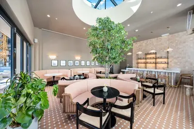 a restaurant with tables and chairs and plants at Luxury 2 Bedroom Corner Unit Crosby Rooftop Pool in Miami