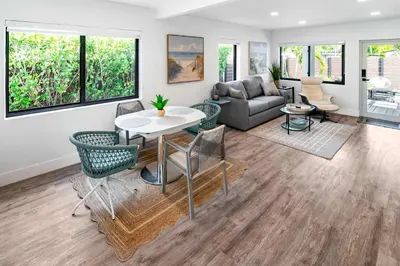 a living room with a couch and a table and chairs at Stylish 2BR Oasis with Pool Mini Golf & BBQ in Fort Lauderdale