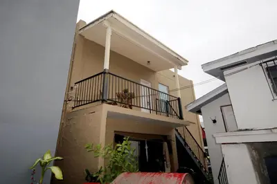 a building with a balcony on the side of it at Historical Little Havana 2 Bed with Parking in Miami