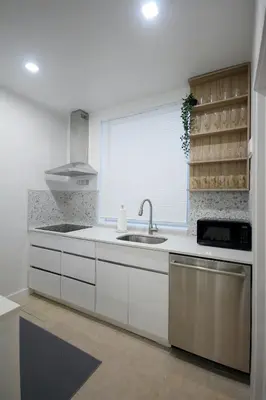 a kitchen with white cabinets and a sink and a window at Historical Little Havana 2 Bed with Parking in Miami