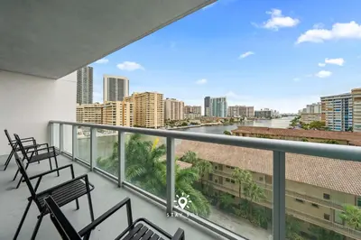 a balcony with chairs and a view of a city at Amazing Apartment with Bay View Balcony Near Beach in Hallandale Beach