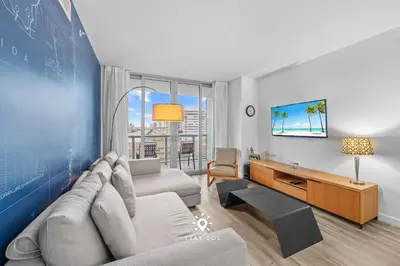 a living room with a couch and a table at Amazing Apartment with Bay View Balcony Near Beach in Hallandale Beach