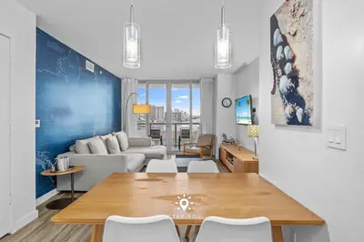 a living room with a table and a couch at Amazing Apartment with Bay View Balcony Near Beach in Hallandale Beach