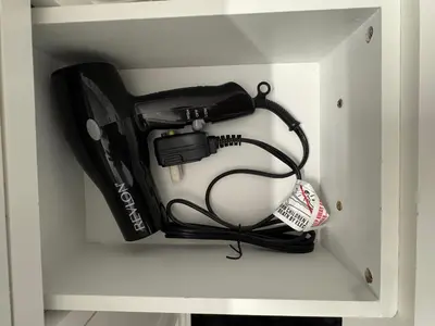 a white cabinet with a hair dryer in it at Private Studio with Patio-King Bed, Near Beach & Casinos in Hollywood