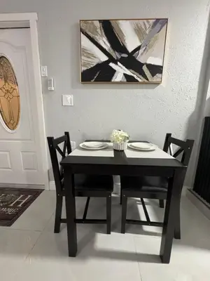 a dining room table with two chairs and a black table at Private Studio with Patio-King Bed, Near Beach & Casinos in Hollywood