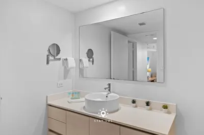 a bathroom with a sink and a mirror at Peaceful Bay View Apartment Near Beach in Hallandale Beach