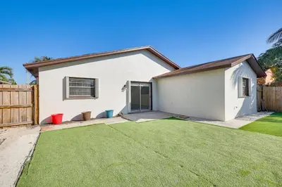 a white house with a fence and a yard at Walk to Shops and Eats, 3 Mi to Beach! Hollywood Gem in Hollywood