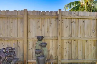 a wooden fence with three sculptures on it at Walk to Shops and Eats, 3 Mi to Beach! Hollywood Gem in Hollywood