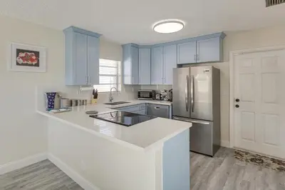 a kitchen with blue cabinets and a white counter top at Walk to Shops and Eats, 3 Mi to Beach! Hollywood Gem in Hollywood