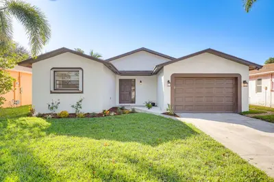 a house with a driveway and a garage at Walk to Shops and Eats, 3 Mi to Beach! Hollywood Gem in Hollywood
