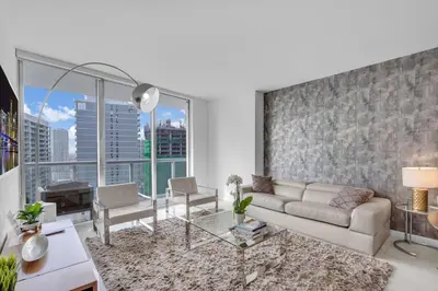 a living room with a couch and a large window at Amazing 1bed at The W icon brickell in Miami