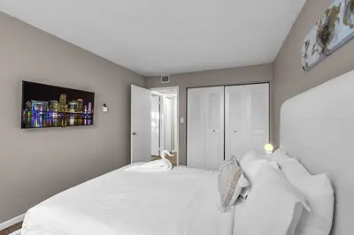 a bedroom with a large white bed with white pillows at Stylish 2BR in North Miami with Free Parking in North Miami