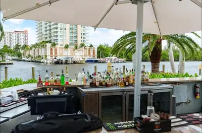 a bar on a boat with a view of a river at Family Tides At GalleryOne in Fort Lauderdale