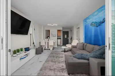 a living room with a couch and a tv at Family Tides At GalleryOne in Fort Lauderdale
