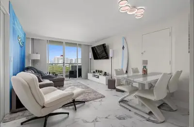 a white living room with a table and chairs at Family Tides At GalleryOne in Fort Lauderdale