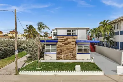 a house with a blue and white facade at Santorini Blu Boutique Beach Studio Steps to Ocean in Hollywood