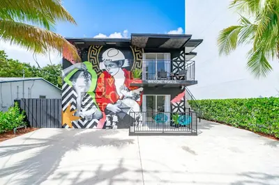 a building with a mural on the side of it at Wynwood Charm, at the Heart of the Art! in Miami
