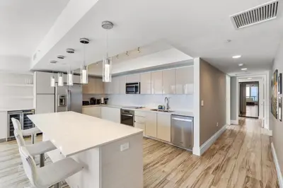 a kitchen with white cabinets and a white counter top at Luxury Oceanview Condo with Private Foyer at Beachwalk Resort in Hallandale Beach