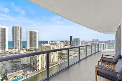 a balcony with a view of the ocean and buildings at Luxury Oceanview Condo with Private Foyer at Beachwalk Resort in Hallandale Beach
