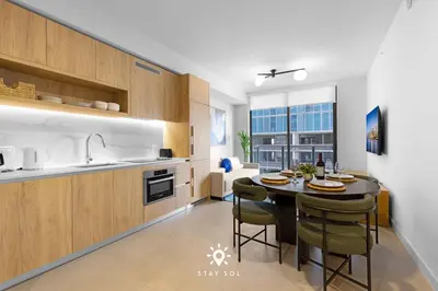 a kitchen with a table and some chairs in a room at 1BR Apartment New Luxury in Miami