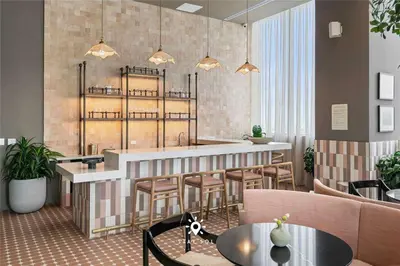 a restaurant with a bar with stools and tables at 1BR Apartment New Luxury in Miami