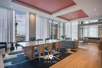a living room with a large table and chairs at Stylish Miami Studio Perfect for City Living in Miami