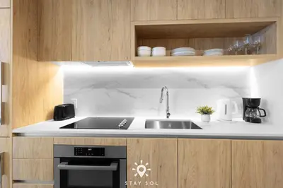 a kitchen with a sink and a stove at Downtown Retreat Pools Spa & Lounges Miami in Miami