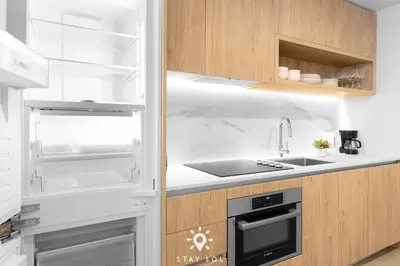 a kitchen with an open refrigerator and a sink at Downtown Retreat Pools Spa & Lounges Miami in Miami