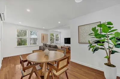 a living room with a table and a potted plant at Victoria Park Oasis Walk to las Olas Beach in Fort Lauderdale