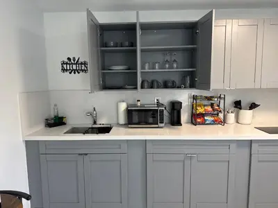 a kitchen with white cabinets and a microwave on a counter at Beautiful 1 bedroom Studio located in Miramar in Miramar