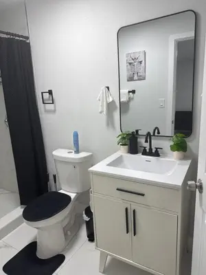 a bathroom with a toilet and a sink and a mirror at Beautiful 1 bedroom Studio located in Miramar in Miramar