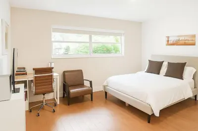 a bedroom with a bed and a desk and a chair at Luxury 4BR Coconut Grove Home wIith Pool and BBQ in Miami