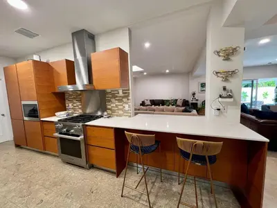 a kitchen with a counter and a stove top oven at Luxury 4BR Coconut Grove Home wIith Pool and BBQ in Miami