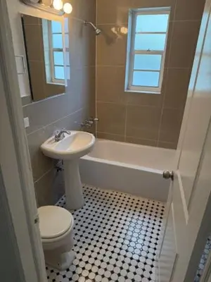 a bathroom with a sink and a toilet and a tub at 9064 Collins Ave 2 in Miami Beach
