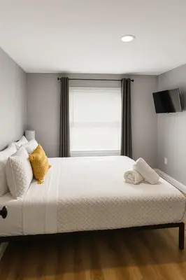 a bedroom with a large white bed with a window at Hollywood Escape in Hollywood