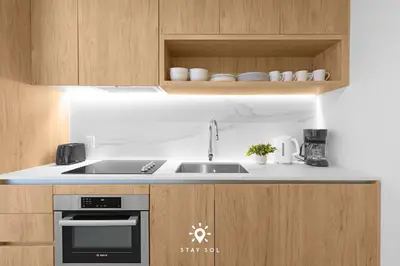 a kitchen with a sink and a stove at Sophisticated Studio with Pools in Miami